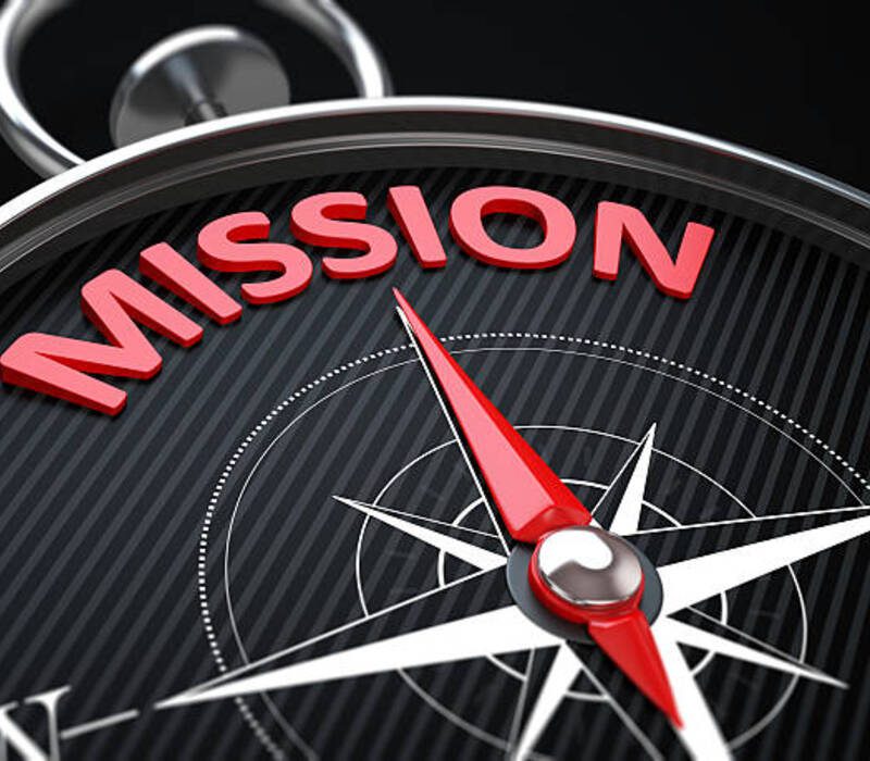 3d render image.  Compass needle pointing the green word mission.