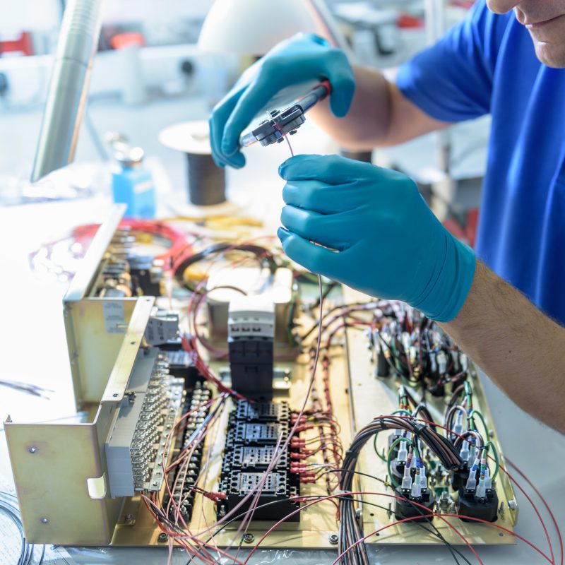 Worker assembling electronics in electronics factory